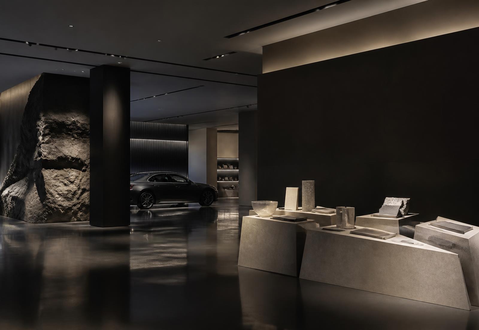 Material plinths in a dark automotive brand space